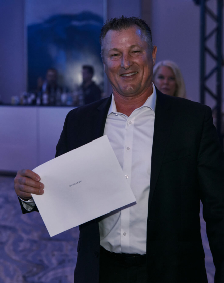 Man holding envelope at 2022 Gala