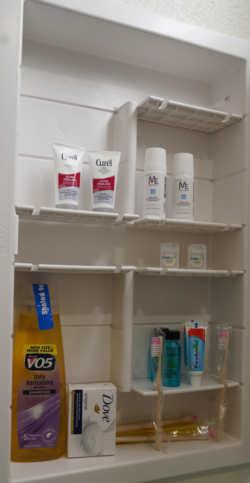A stocked bathroom cabinet at The Hacienda Townhomes