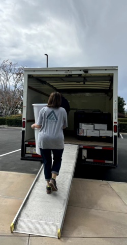 Volunteer loading supplies into the back of a truck