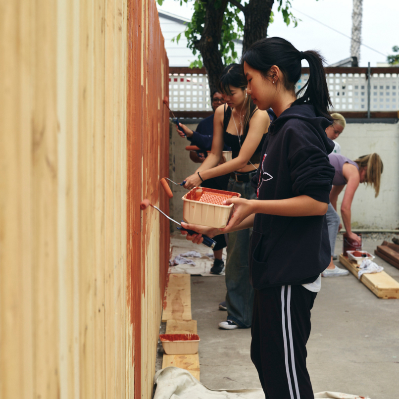 A photo of a person painting at the Allgire Volunteer Day