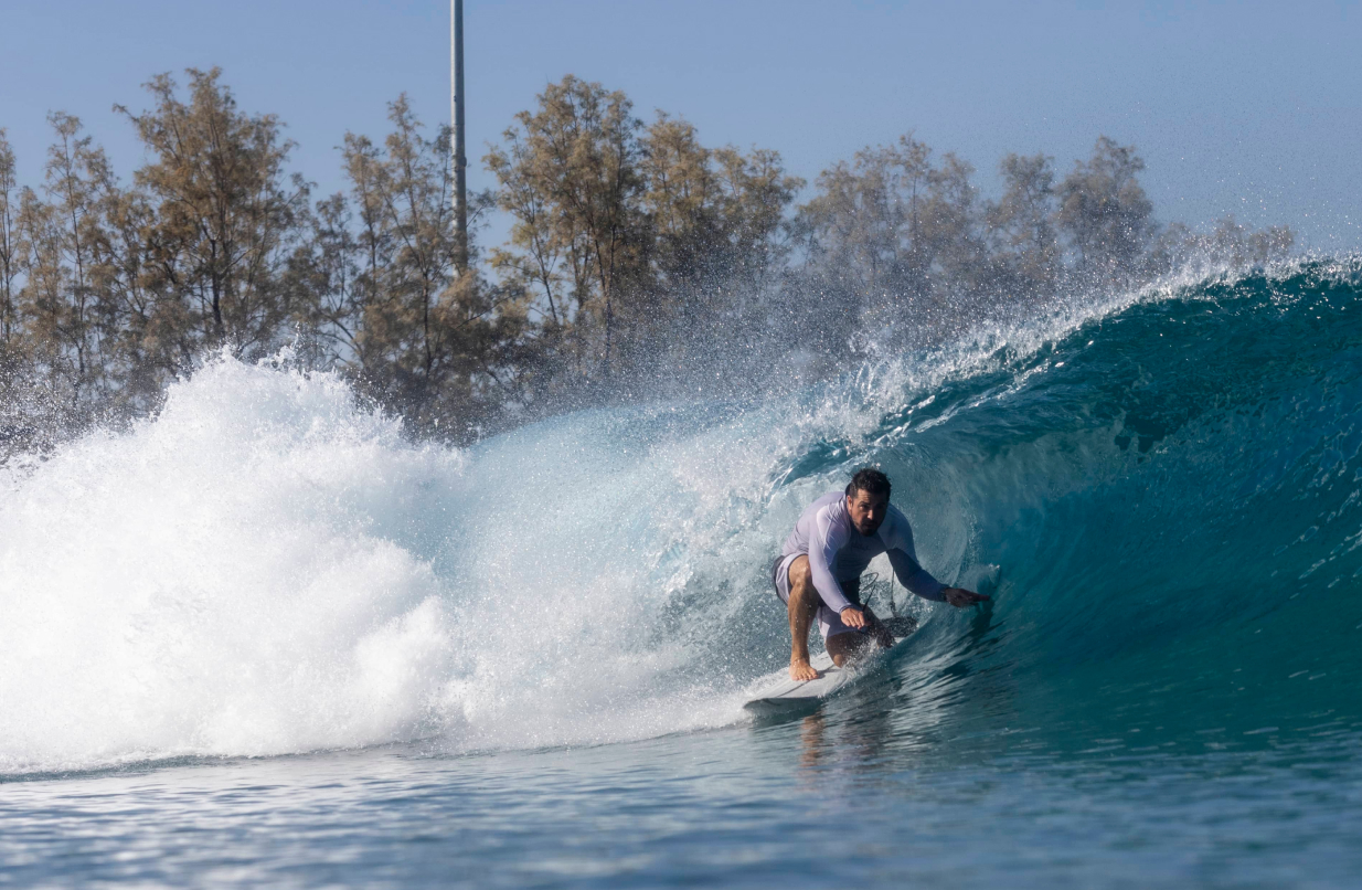 Photo of a surfer going under a wave
