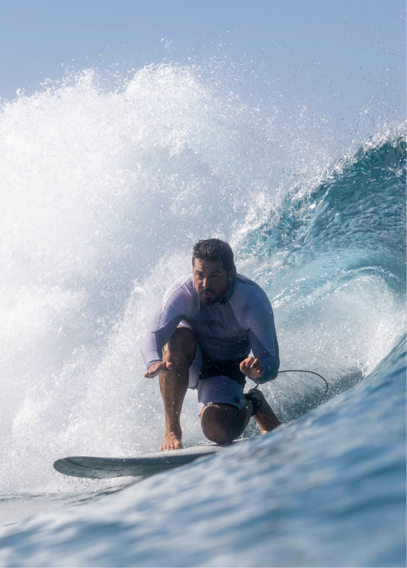 Close up photograph of a man surfing at the Kelly Slater Surf Ranch Trip