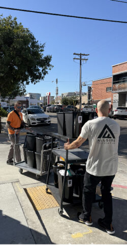 Volunteers with a cart of supplies