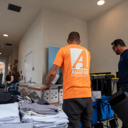 A volunteer helping while wearing an Allgire Foundation shirt