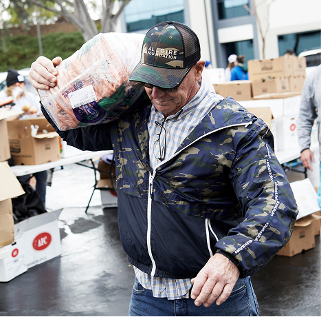 A photograph of a volunteer at Spring Harvest 2022 carrying a bag on his shoulder