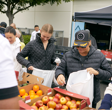 Volunteers putting produce into bags