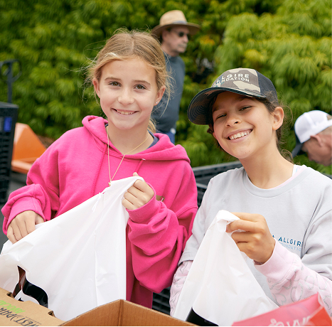 A photograph of two young volunteers at spring harvest 2023