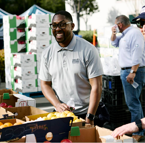 A volunteer smiling at the spring harvest