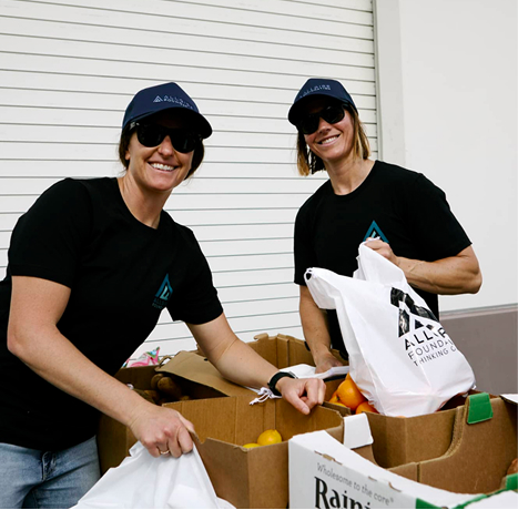 Two volunteers packing bags