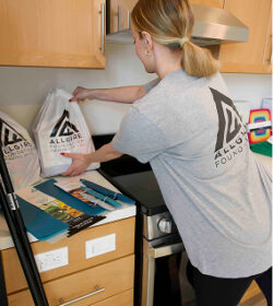 A volunteer setting out Allgire Foundation bags on the counter