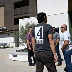 A volunteer with the Allgire Foundation logo on the back of his shirt